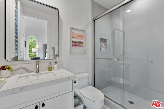 a large bathroom with a double vanity sink a large mirror and a shower