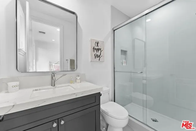 a view of a patio with table and chairs potted plants with floor to ceiling window