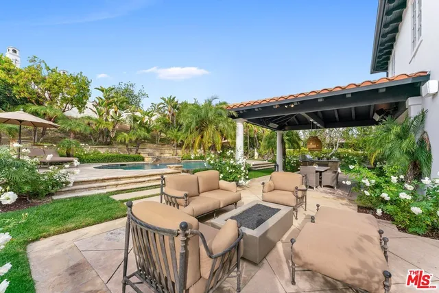 a view of a house with pool and chairs