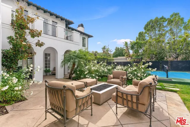 a view of a house with swimming pool and sitting area