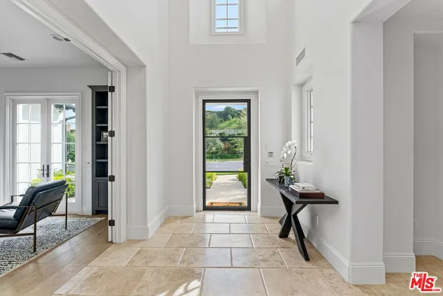 a living room with furniture a fireplace and a potted plant