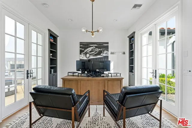 a living room with furniture flowerpot and wooden floor