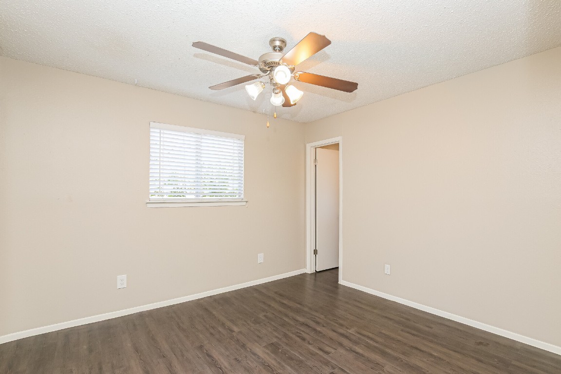 5201 Evans Avenue, Unit A Austin, TX 78751 - Photo 12 of 16 an empty room with wooden floor fan and windows