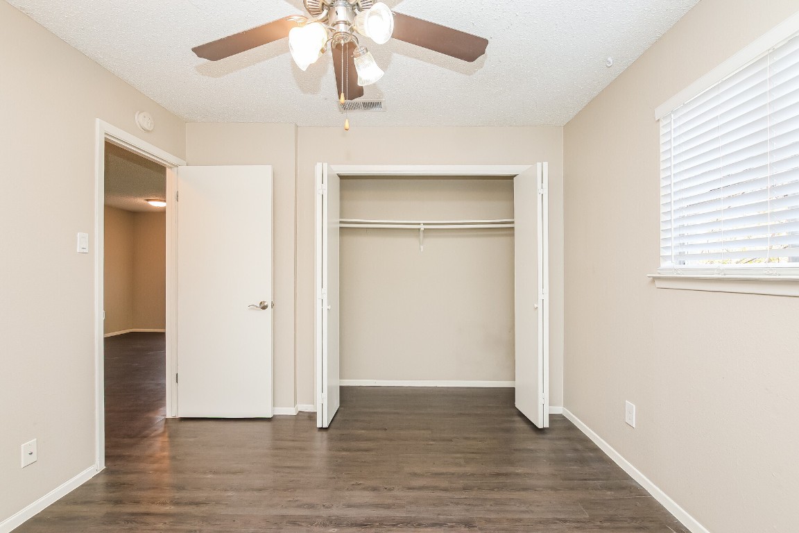 5201 Evans Avenue, Unit A Austin, TX 78751 - Photo 13 of 16 an empty room with wooden floor closet and windows