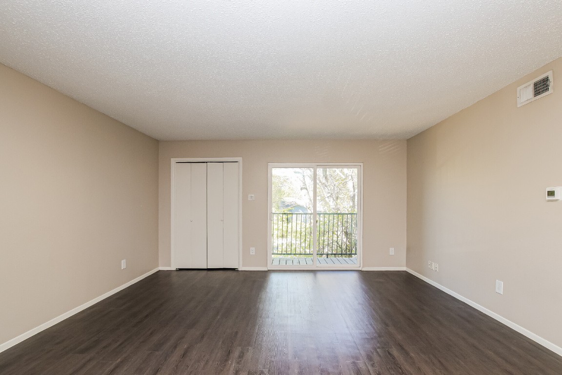 5201 Evans Avenue, Unit A Austin, TX 78751 - Photo 5 of 16 an empty room with wooden floor and windows