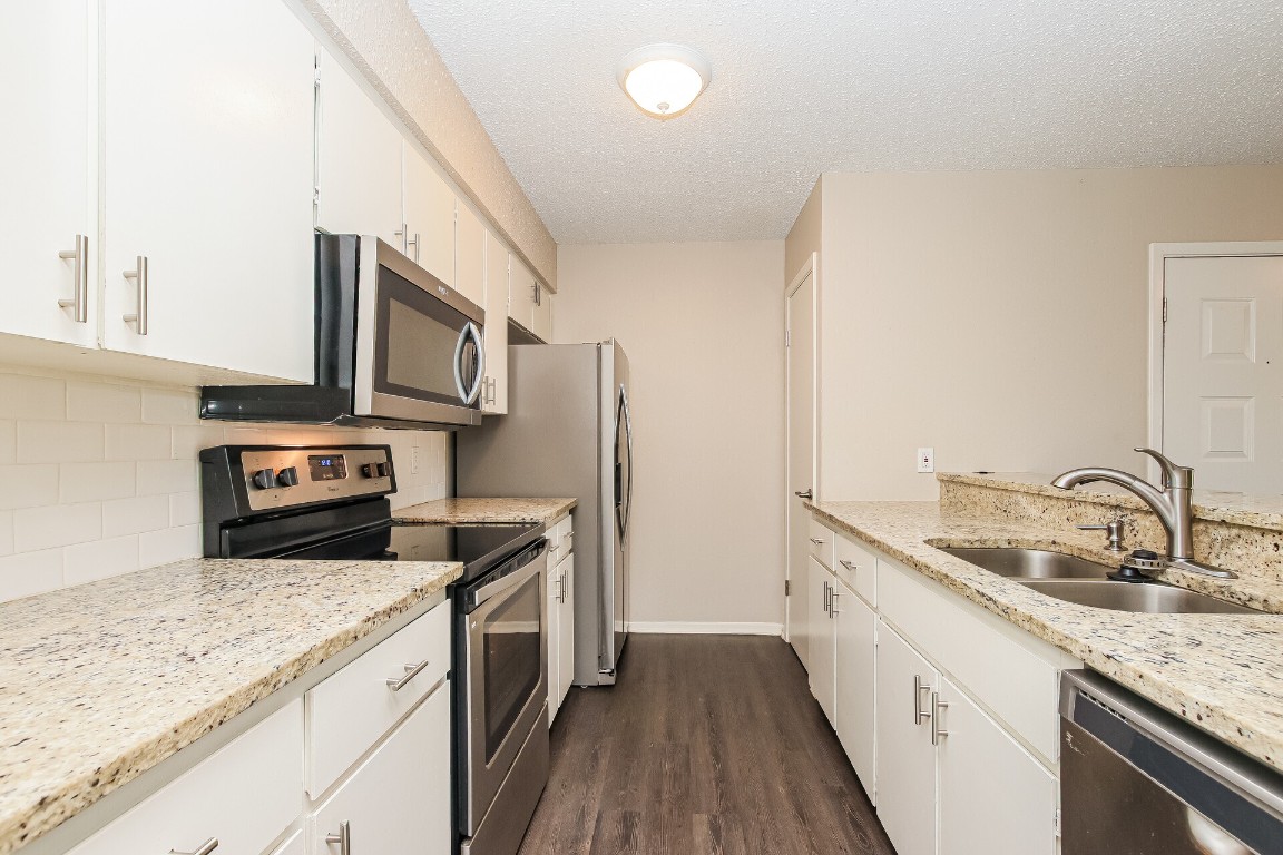5201 Evans Avenue, Unit A Austin, TX 78751 - Photo 7 of 16 a kitchen with stainless steel appliances granite countertop a sink stove and refrigerator