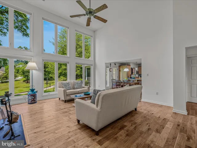 a kitchen with stainless steel appliances a dining table chairs and wooden floor