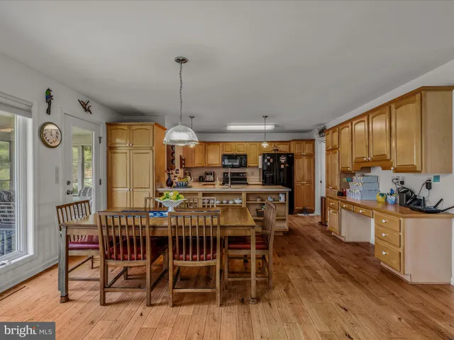 a dining room with furniture and a floor to ceiling window