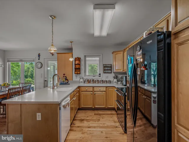 a bedroom with a bed dresser and window