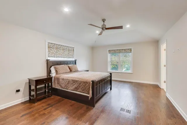 a bedroom with a bed a window and closet