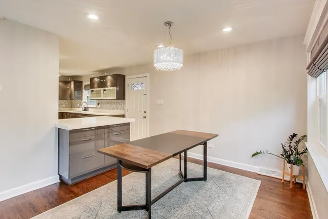 a view of a kitchen area with furniture and wooden floor