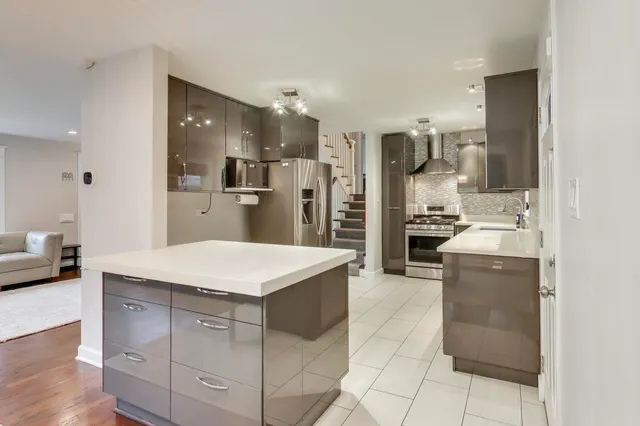 a kitchen with kitchen island cabinets and refrigerator