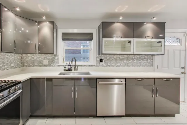 a kitchen with a sink stainless steel appliances and cabinets