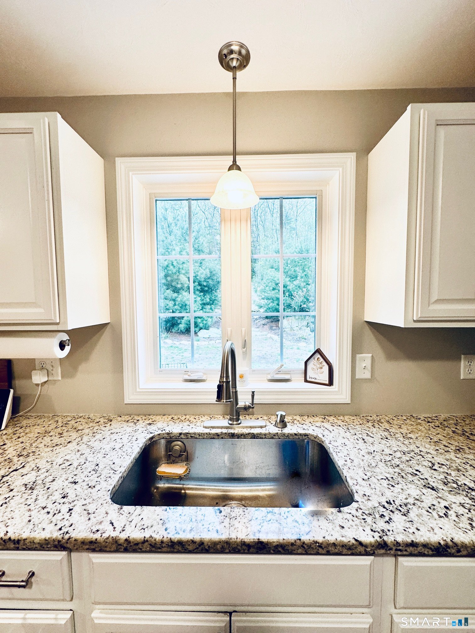 29 Logans Lane Thompson, CT 06277 - Photo 13 of 40 a kitchen with granite countertop a sink a window and cabinets