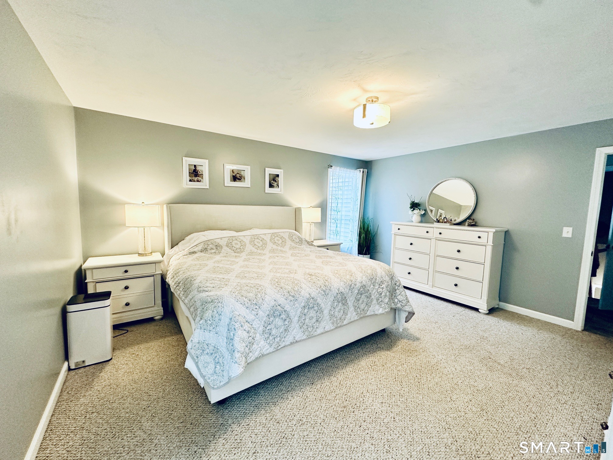 29 Logans Lane Thompson, CT 06277 - Photo 16 of 40 a bedroom with a bed and a lamp on dresser