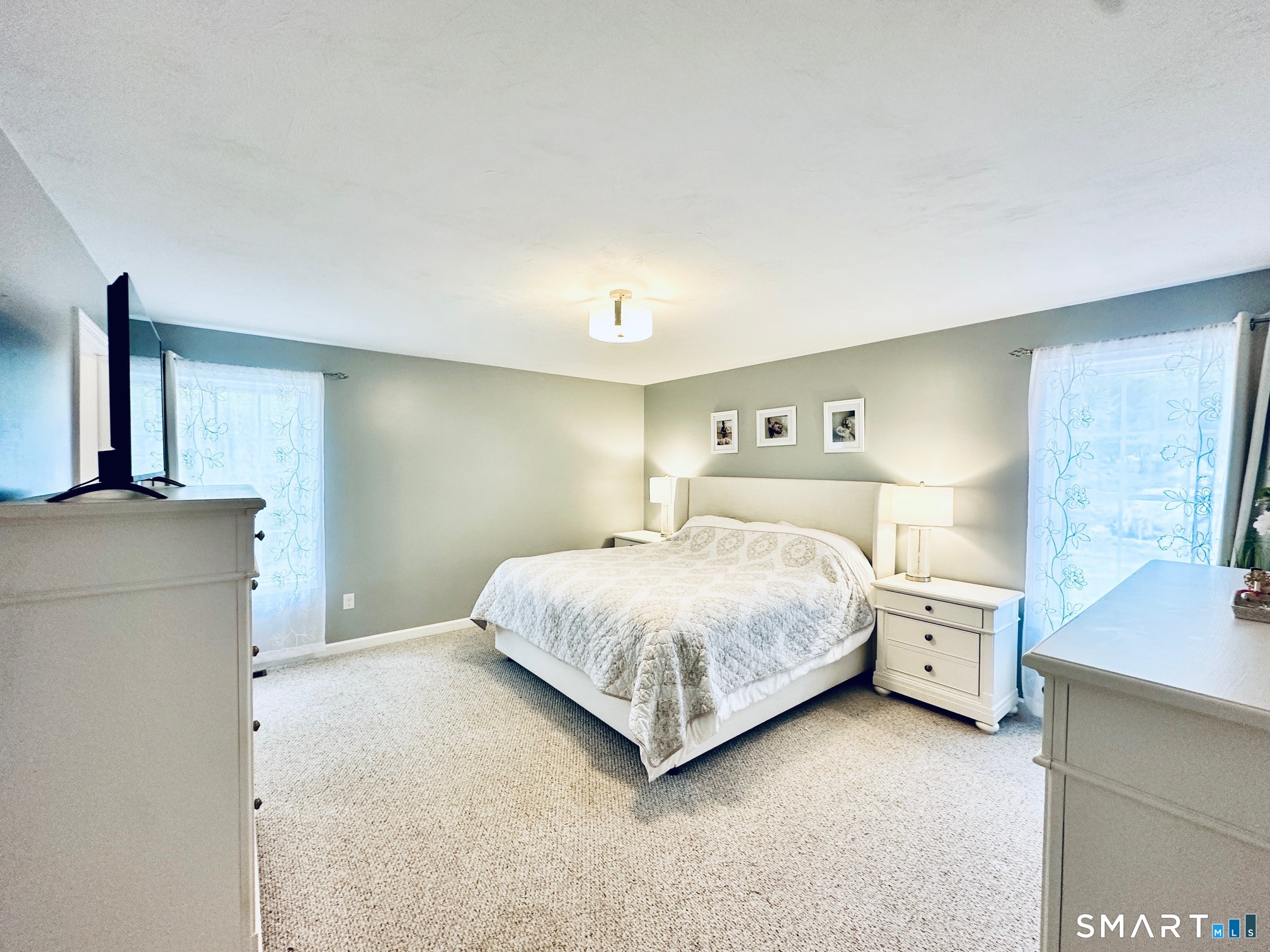 29 Logans Lane Thompson, CT 06277 - Photo 17 of 40 a bedroom with a bed and a refrigerator