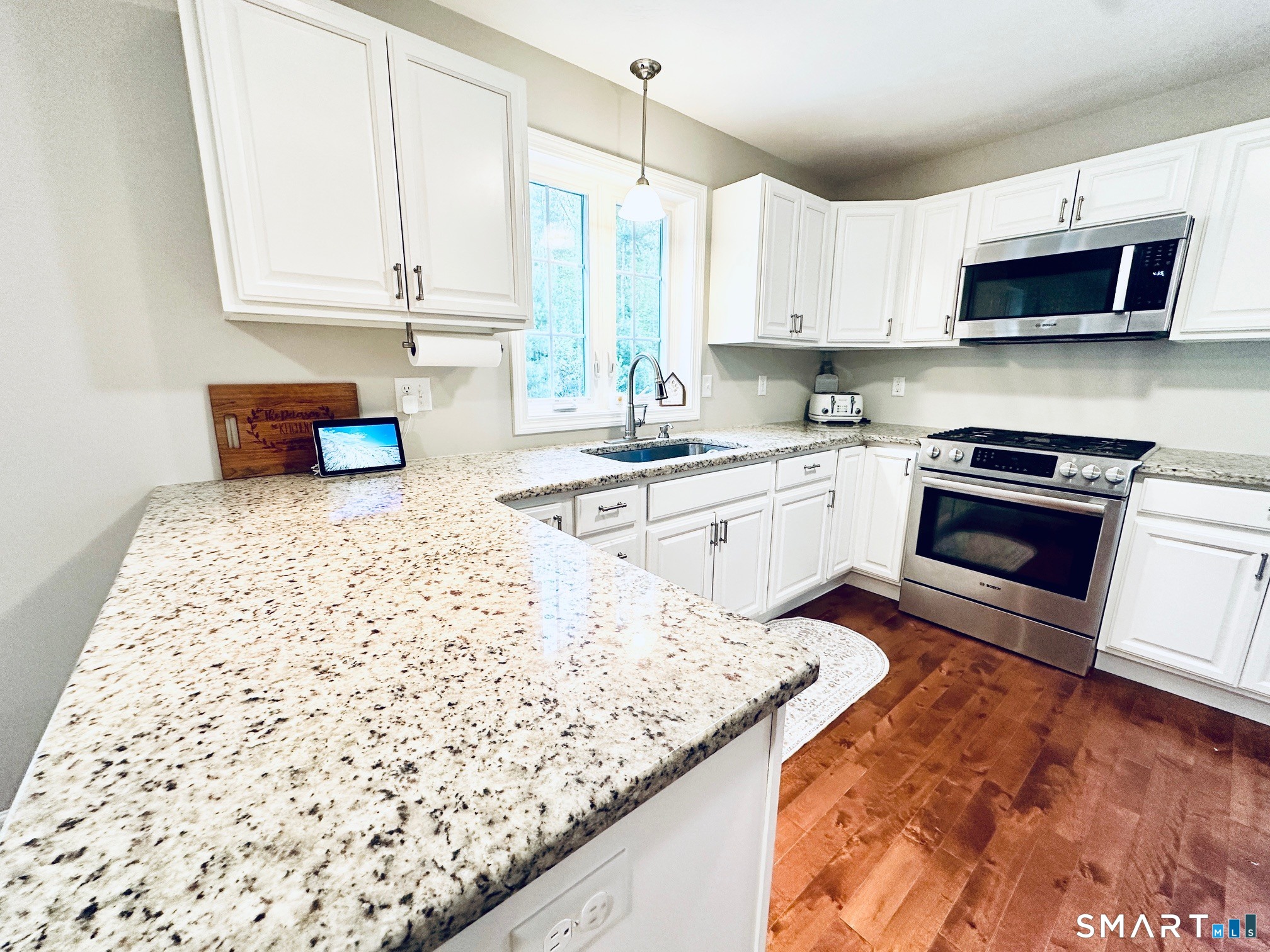 29 Logans Lane Thompson, CT 06277 - Photo 8 of 40 a kitchen with stainless steel appliances granite countertop a stove a sink and a microwave