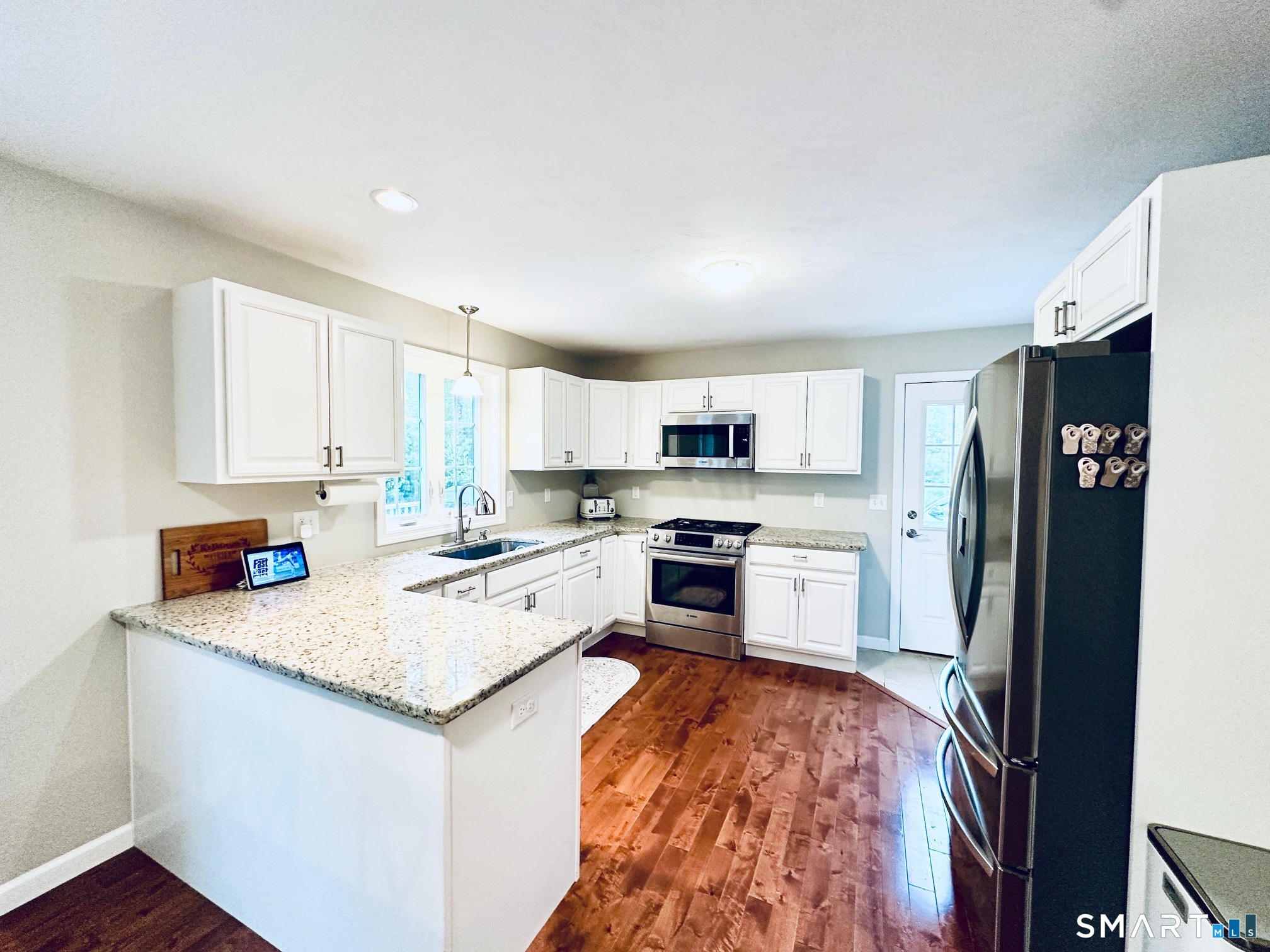 29 Logans Lane Thompson, CT 06277 - Photo 10 of 40 a kitchen with stainless steel appliances granite countertop a refrigerator stove microwave and sink