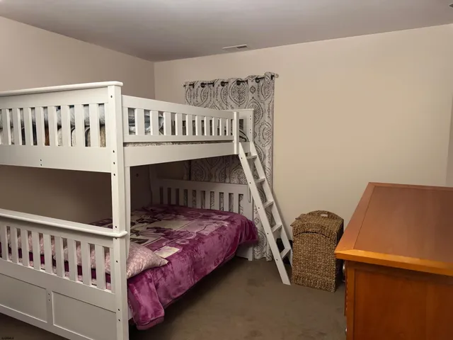 a bedroom with bed and a window