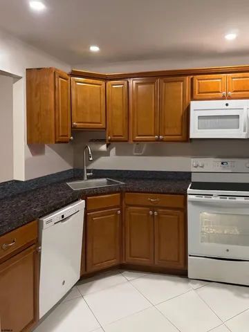 a kitchen with stainless steel appliances granite countertop a sink and cabinets