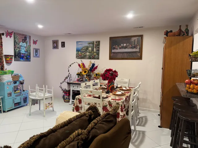a living room with furniture and flowers