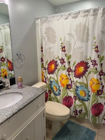 a bathroom with a sink mirror vanity and toilet