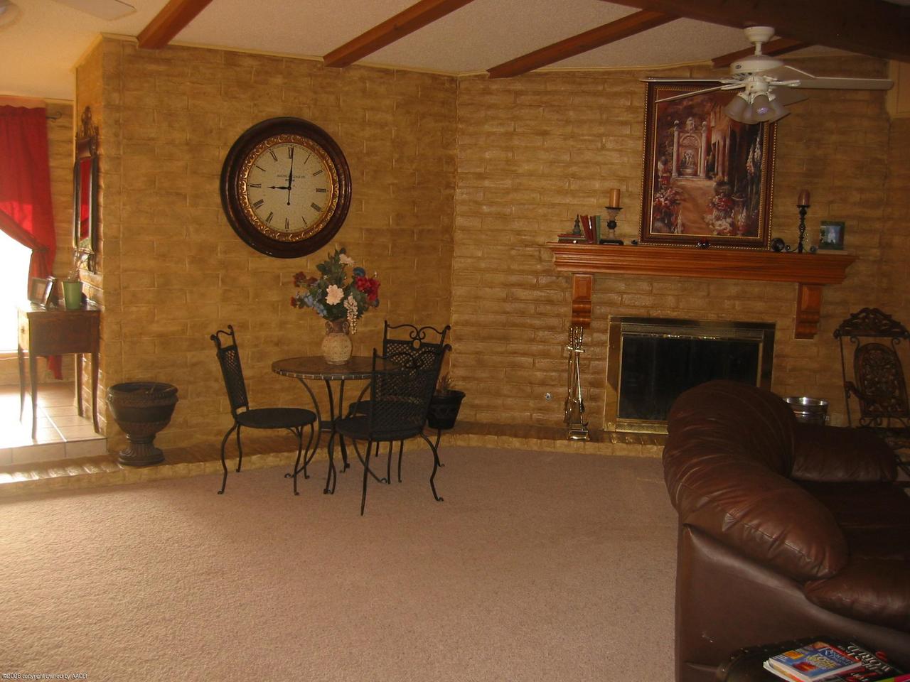 7904 Goodnight Trail Amarillo, TX 79110 - Photo 3 of 13 a living room with furniture and a fireplace