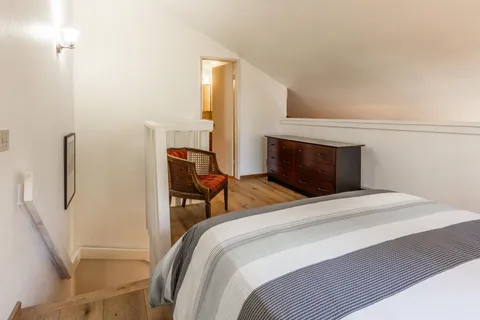 a bedroom with a bed and chair