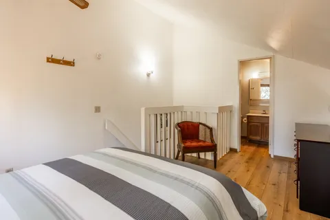 a bedroom with a bed and chair