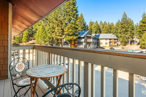 a view of a balcony with chairs and table