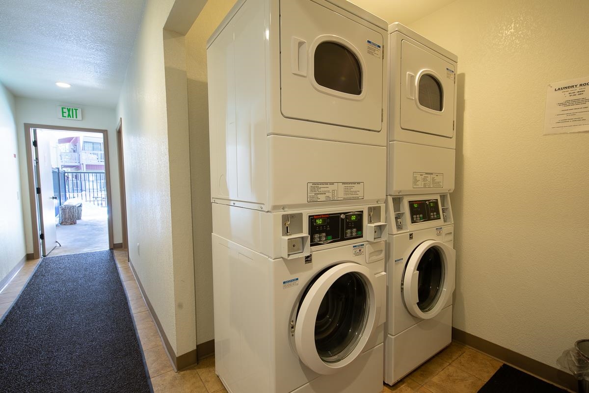 153 Lake Mary Road, Unit 132 Mammoth Lakes, CA 93546 - Photo 28 of 32 Community laundry featuring stacked washer / dryer, a textured wall, and a textured ceiling