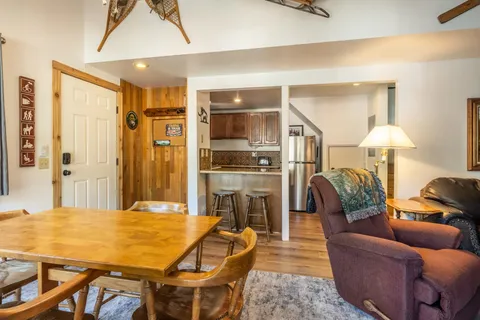 a dining room with furniture and a kitchen view
