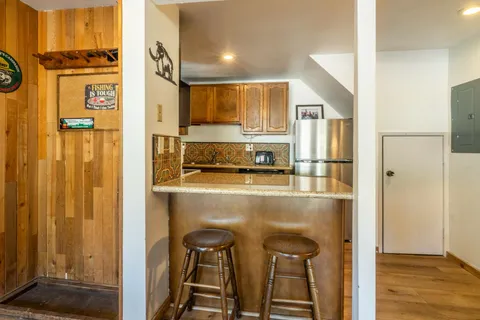 a kitchen with stainless steel appliances granite countertop a refrigerator and a stove