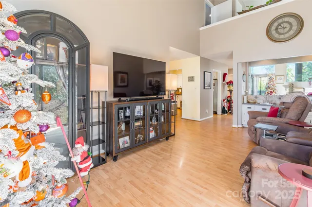 a bedroom with a bed a flat screen tv and next to a window