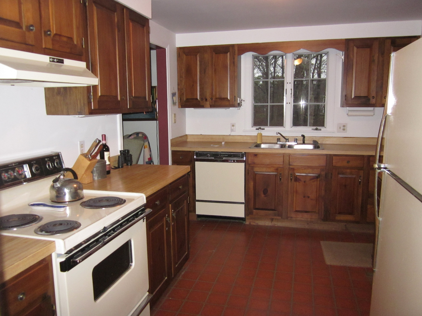 59 Marthas Road Edgartown, MA 02539 - Photo 4 of 17 a kitchen with granite countertop a sink stove and cabinets
