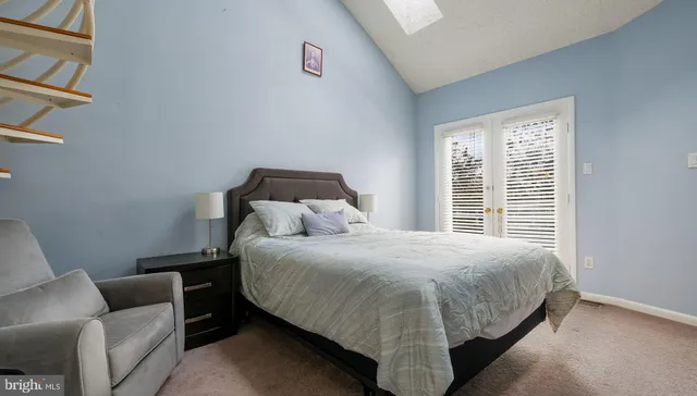 a bedroom with a bed couch and a window