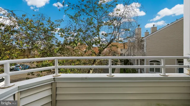a view of a balcony with lots of green space