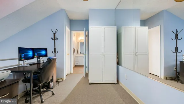 a view of a livingroom with workspace and a flat screen tv