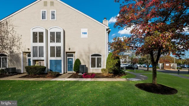 a front view of building with yard and green space