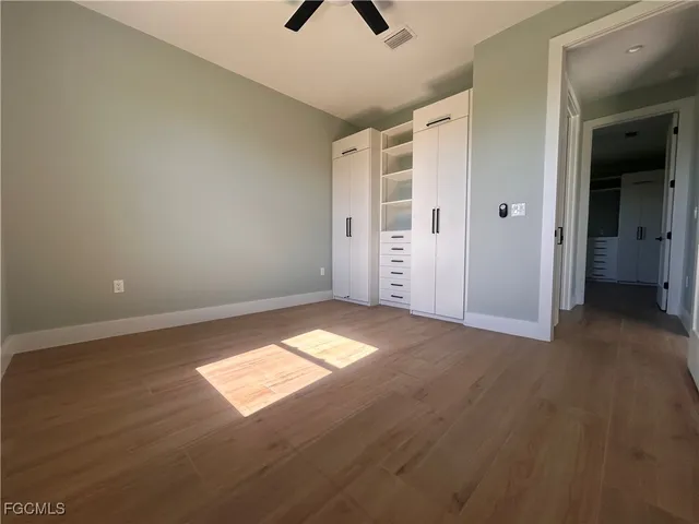 an empty room with windows and closet
