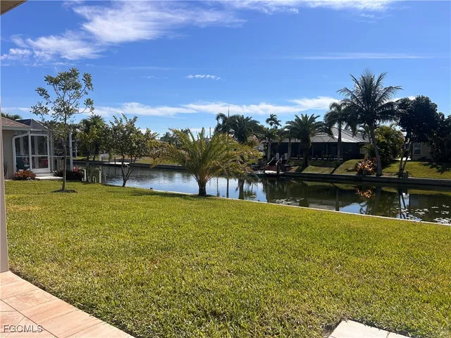 a view of a swimming pool with an outdoor seating and a yard