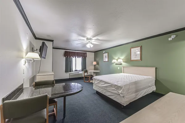 a bedroom with furniture and a chandelier