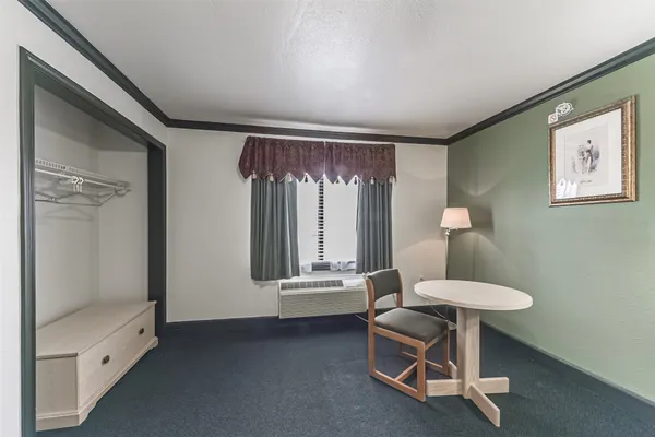 a bedroom with a bed and a dresser