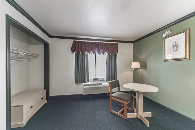 a bedroom with a bed and a dresser