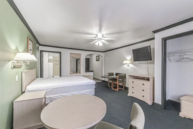 a bedroom with a bed furniture and a chandelier