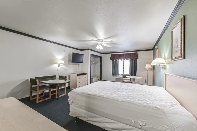 a en suite bathroom with a granite countertop sink and a mirror