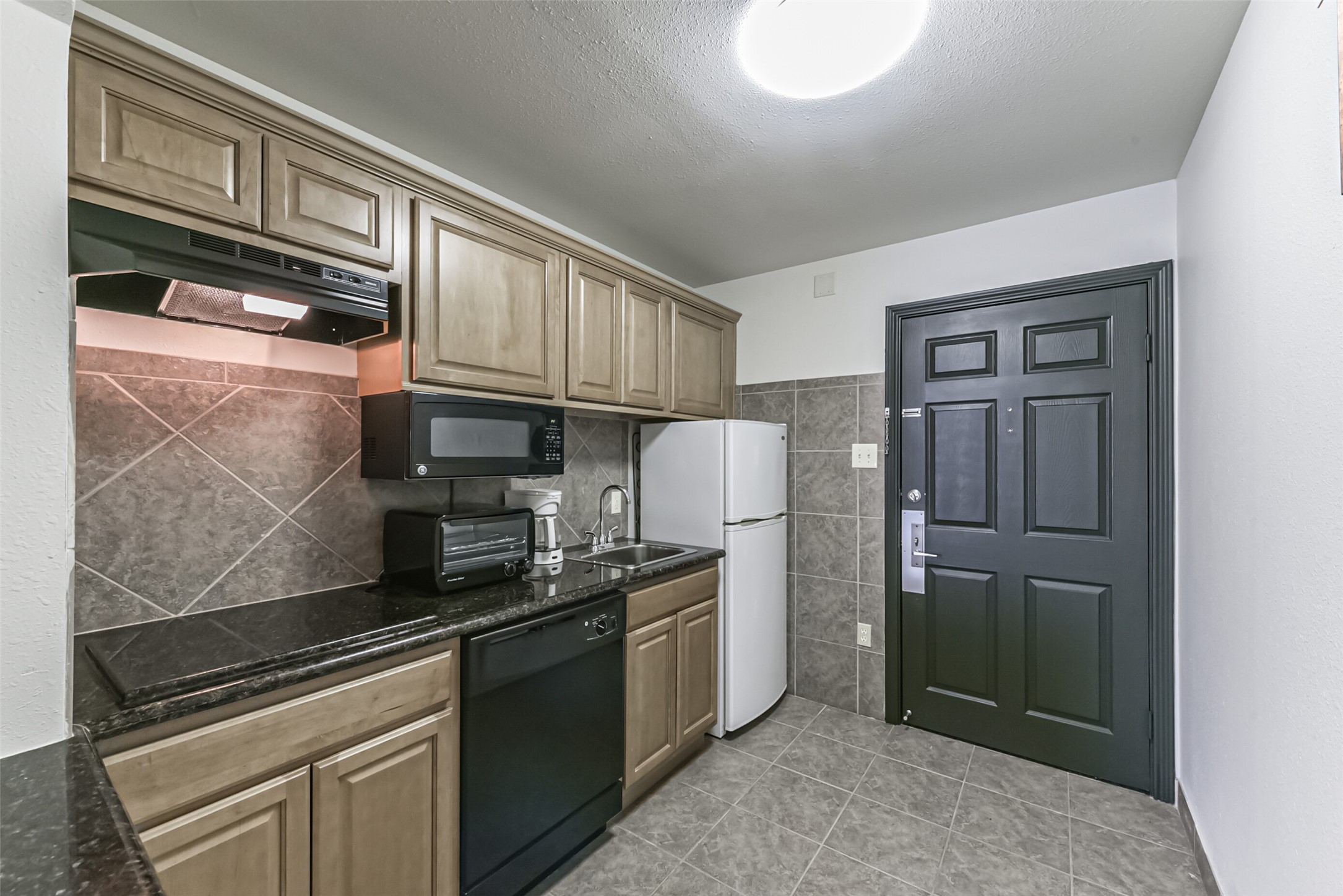 1025 Swanson Street, Unit 314 Houston, TX 77030 - Photo 20 of 25 a kitchen with stainless steel appliances granite countertop a refrigerator and a stove top oven