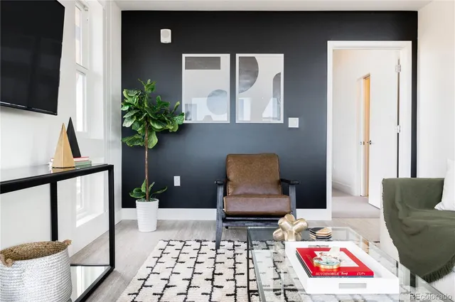 a living room with furniture and a potted plant