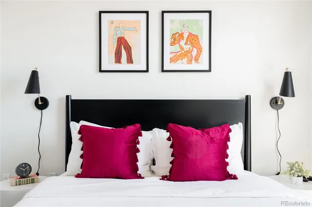 a room with a bed and a painting on the wall