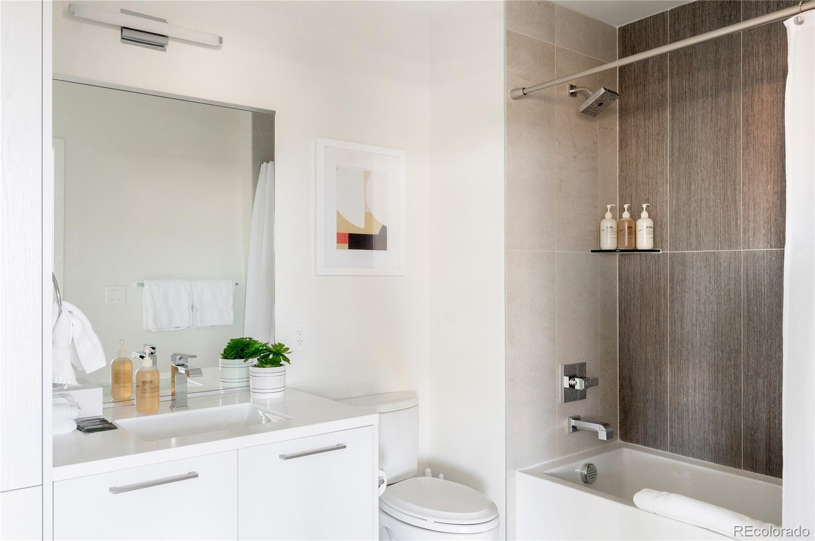 2880 Zuni Street, Unit 404 Denver, CO 80211 - Photo 26 of 30 a bathroom with a sink a toilet and shower